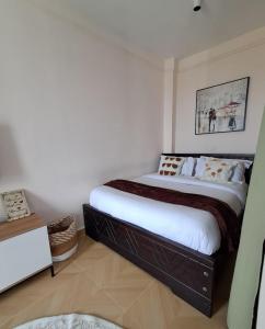 a bedroom with a large bed in a room at Reily Luxury Homes - Studio Apartment, Syokimau near JKIA & SGR, PARK VIEW in Nairobi +3 photos