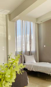 a bedroom with a bed and a window with a plant at Downtown Studio 41 in Serres