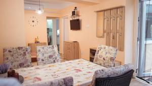 a dining room with a table and four chairs at Tavasz apartman in Balatonfenyves +20 photos