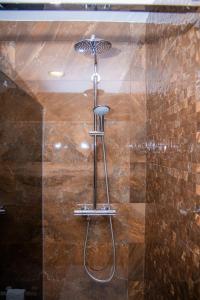 een douche met een chromen douchekop in de badkamer bij Casa Rural La Bodega de Cortés in Villagonzalo