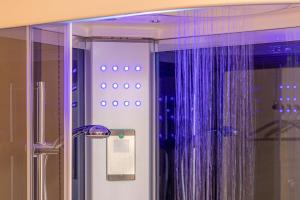 a bathroom with a shower with purple curtains at Venus Suite - Romantic Private Spa - Centro Livorno in Livorno
