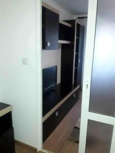 a room with a sliding glass door with a television at Apartament Decebal- 2 dormitoare in Bistriţa