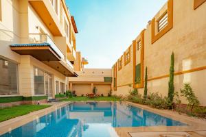 a swimming pool in the courtyard of a building at Luxury Accommodation in Sheikh Zayed