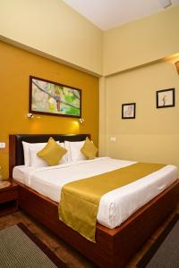 a bedroom with a large bed in a room at Arara Mhas Hotel in Cherrapunji