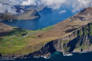 una vista aerea di una montagna con una cassa d'acqua di Eiðsvíkslon - The Red Boathouse by the Sea a Viðareiði Altre 26 foto