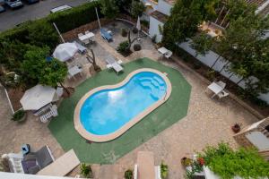 カニャメルにあるApartamentos La Cabañaのスイミングプール(椅子、パラソル付)のオーバーヘッドビュー