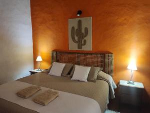 a bedroom with a bed with two pillows on it at Cabañas Balcones de Tafi in Tafí del Valle +40 photos
