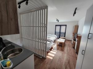 a kitchen with a bed in the middle of a room at Alexander The Great ATG in Skopje