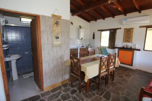 a kitchen and dining room with a table and chairs at Cabañas Balcones de Tafi in Tafí del Valle