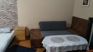 a living room with a couch and a chair at FEIDUM quarters flat in Kraków