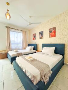 zwei Betten in einem Hotelzimmer mit zwei Betten in der Unterkunft Majestic Apex Residence in Bamburi