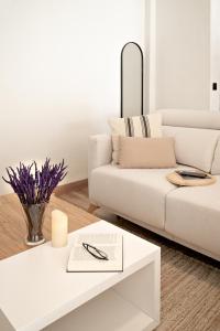 a living room with a white couch and a table at Chez Marie in La Muela