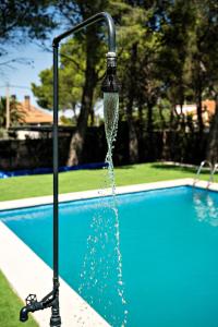 a water fountain in front of a swimming pool at Chez Marie in La Muela