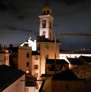 a building with a clock tower on top of it at La Gatta sui Tetti in Osimo