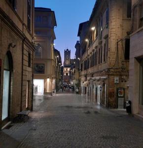 an empty street in an old city at night at La Gatta sui Tetti in Osimo