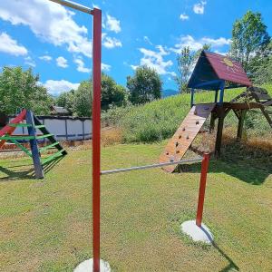 a playground with a slide and a swing set at Horská chaloupka Bělá pod Pradědem in Bělá pod Pradědem