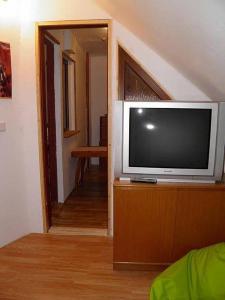a flat screen tv sitting on a dresser in a living room at Horská chaloupka Bělá pod Pradědem in Bělá pod Pradědem +49 photos