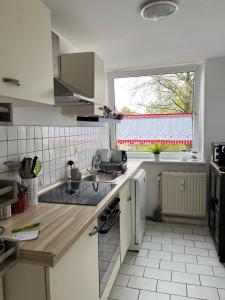 a kitchen with a sink and a window at Ferienwohnung in Landsberg am Lech in Landsberg am Lech +4 photos