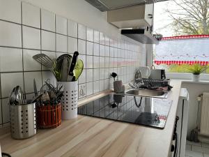 a kitchen with a sink and a counter with utensils at Ferienwohnung in Landsberg am Lech in Landsberg am Lech