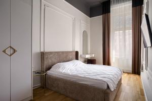 Ένα ή περισσότερα κρεβάτια σε δωμάτιο στο Bulevard Suite