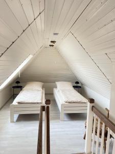 two beds in a room with a attic at Design Apartment in Carolinensiel in Carolinensiel