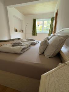a large bed with pillows on it in a bedroom at Traunapartment Altaussee in Altaussee