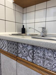 a kitchen counter with a sink and a counter top at Traunapartment Altaussee in Altaussee +33 photos