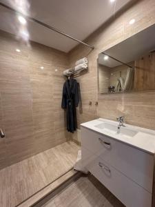 a bathroom with a sink and a mirror at Appart familial avec terrasse et piscine, à 2 pas de la plage des nations - Rabat in Sidi Bouqnadel