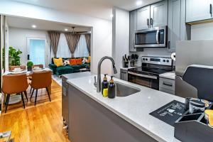 Christmas special, Cozy Luxe Escape, Raleigh 2BR Getaway, Sleeps 4, Pets, Kids & Business Travelers Welcome, Holiday deal في رالي: مطبخ مع حوض وطاولة عمل