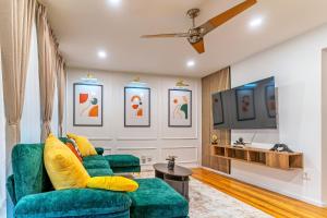 Christmas special, Cozy Luxe Escape, Raleigh 2BR Getaway, Sleeps 4, Pets, Kids & Business Travelers Welcome, Holiday deal في رالي: غرفة معيشة مع أريكة خضراء وتلفزيون