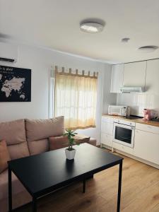 a living room with a couch and a table at Libertad A in Santiponce