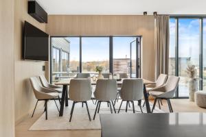 a dining room with a table and chairs at Arctic aurora lodge with jacuzzi and sauna in Lyngværet