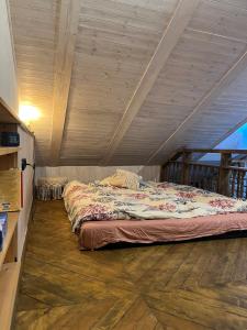 a bed in a room with a wooden ceiling at Apartment in Pelgulinn in Tallinn