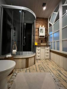 a bathroom with a tub and a sink and a microwave at Apartment in Pelgulinn in Tallinn