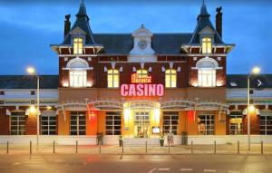 a large brick building with a casino sign on it at REPOS 150m plage Coeur de Berck in Berck-Plage