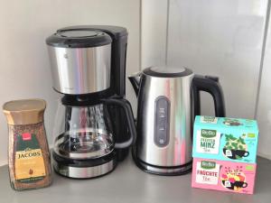a coffeemaker and a coffee maker on a counter at Quiet & Modern Studio near Tram & River Lech in Augsburg