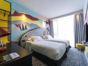 a hotel room with two beds and a desk at ibis Styles Tbilisi Center in Tbilisi City +99 photos