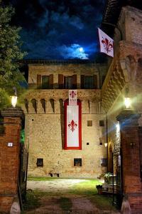 a building with a sign on the side of it at Castello del Capitano delle Artiglierie in Castrocaro Terme