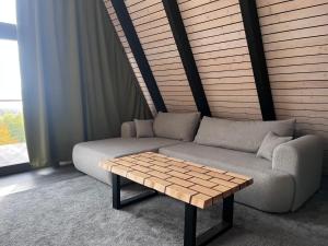a living room with a couch and a coffee table at A frame Miška in Nána