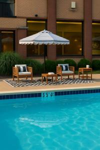 a swimming pool with two chairs and an umbrella and a table and chairs sidx sidx at Solomons Inn Resort and Marina in Solomons