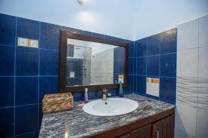 a bathroom with a sink and a mirror at Mountvilla Exquisite 4-Bedroom Luxury Retreat with Private Pool in Galle +51 photos