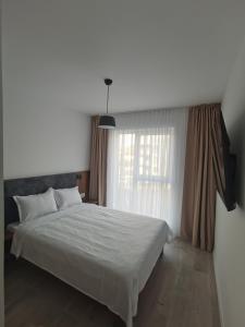 Postel nebo postele na pokoji v ubytování Enjoy Daliei Apartment