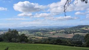 a view of a green field with mountains in the distance at Views for miles in Monmouth