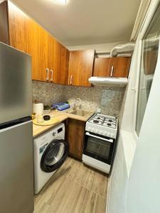 a small kitchen with a stove and a washer at BDR Residence in Craiova