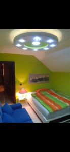 a bedroom with a bed and a green wall at Alibi in Šabac