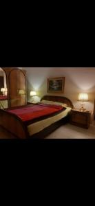 a bedroom with a bed with a red bedspread at Alibi in Šabac +9 photos