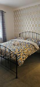 a bed in a bedroom with a bedspread on it at The Park Inn in Stockton-on-Tees