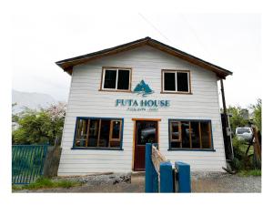 a white building with a furka house on it at Futa House in Futaleufú