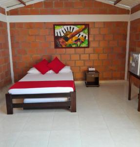 a bedroom with a bed in a brick wall at Ecohotel don Salvador in Ulloa