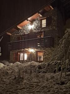 a stone house with lights on the side of it at Chalet coeur d'alpage La Plagne Les Arcs in La Plagne Tarentaise